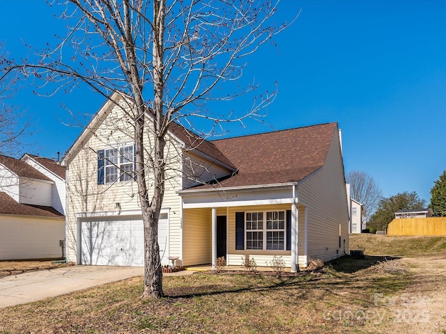 traditional-style home featuring a garage, concrete driveway, and a front yard