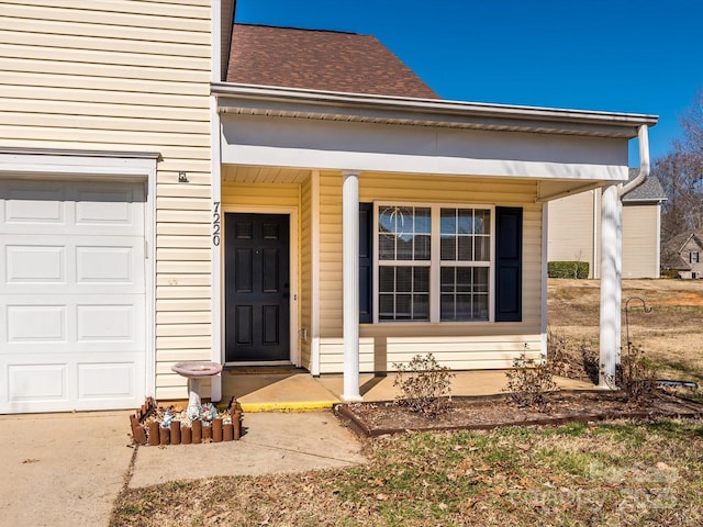 doorway to property featuring a shingled roof