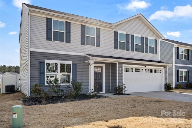 view of front of house with a garage, central air condition unit, and concrete driveway