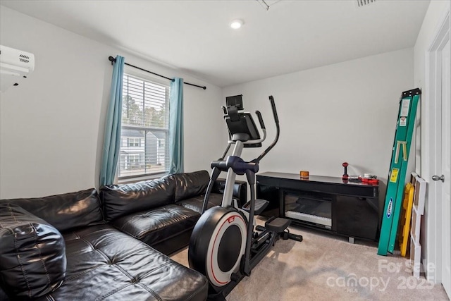 exercise room featuring carpet and an AC wall unit