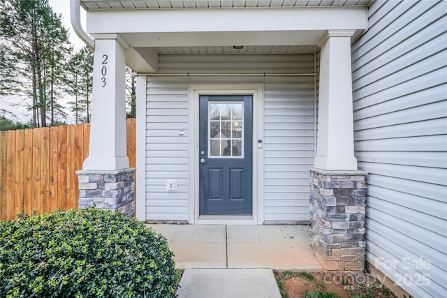 entrance to property featuring fence