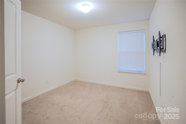 empty room featuring carpet flooring and baseboards