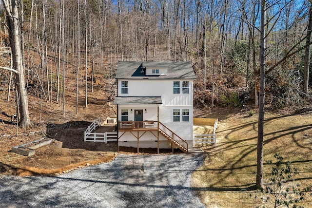 view of front of home featuring driveway and stairway