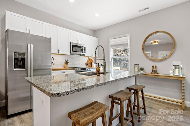 215 David Ridge Rd, Black Mountain, NC 28711 - kitchen with white cabinets, visible vents, stainless steel appliances, and a sink