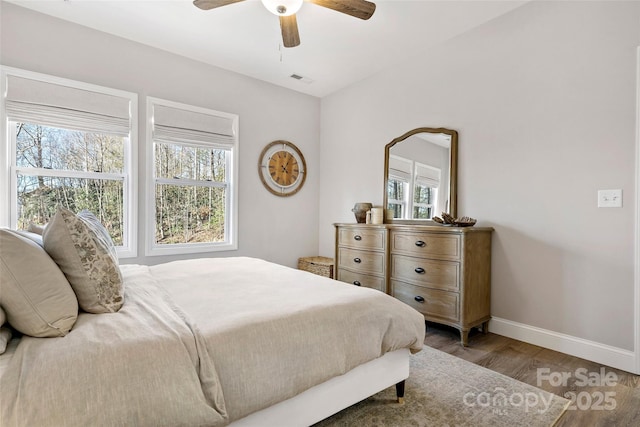 215 David Ridge Rd, Black Mountain, NC 28711 - bedroom with ceiling fan, multiple windows, baseboards, and wood finished floors