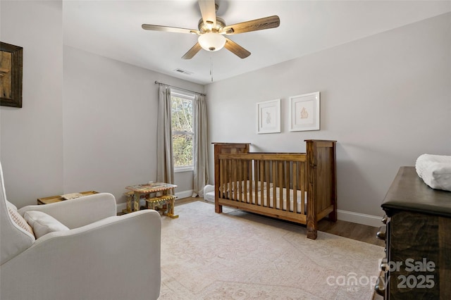 215 David Ridge Rd, Black Mountain, NC 28711 - bedroom with a crib, a ceiling fan, visible vents, baseboards, and light wood finished floors