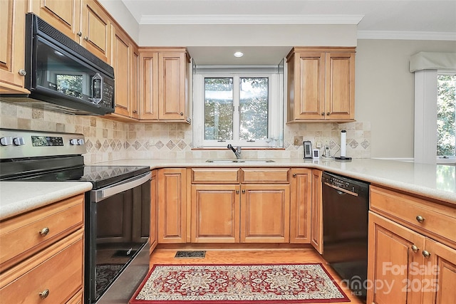 kitchen featuring ornamental molding, a sink, black appliances, and tasteful backsplash