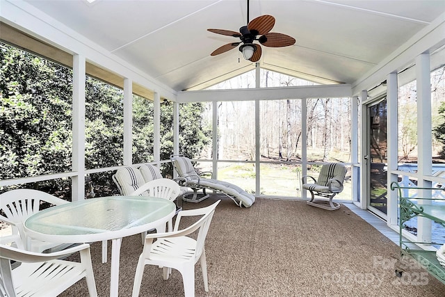 sunroom with ceiling fan and vaulted ceiling