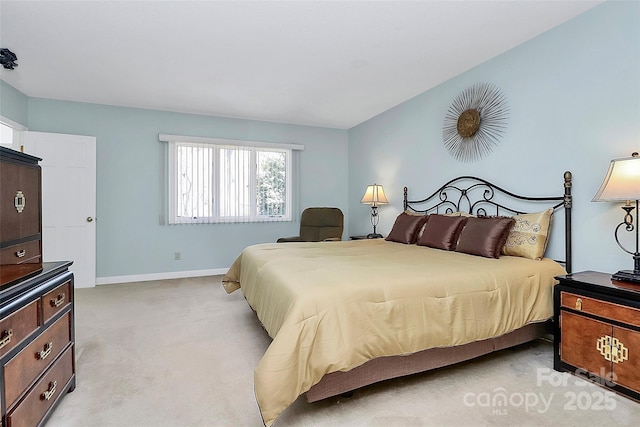 bedroom with baseboards and light colored carpet