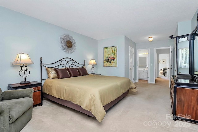 bedroom with light carpet and ensuite bath