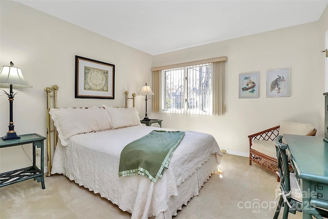 bedroom featuring light colored carpet and baseboards