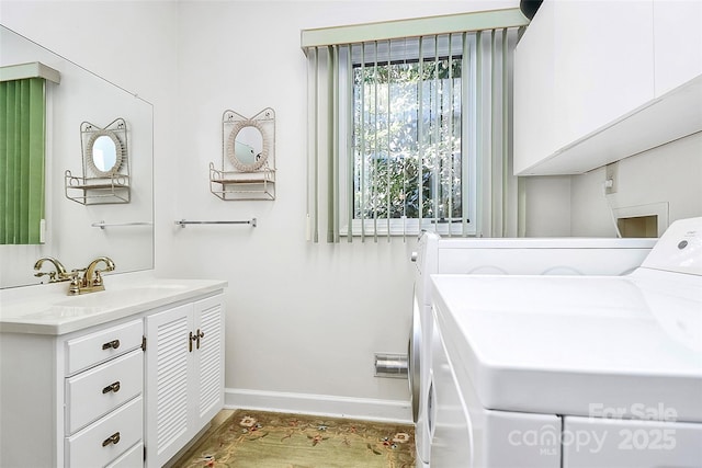 laundry area featuring washer hookup, cabinet space, baseboards, and a sink