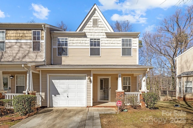 view of front of home with an attached garage, covered porch, and concrete driveway