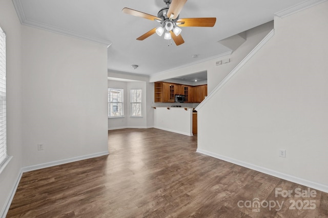 unfurnished living room featuring ornamental molding, dark wood-type flooring, and baseboards