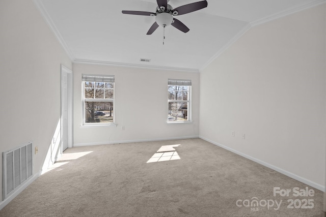 empty room featuring vaulted ceiling, ornamental molding, carpet flooring, and visible vents