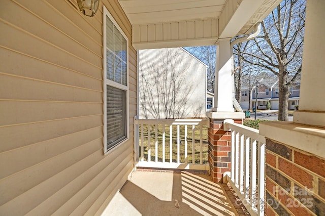 balcony featuring a sunroom and a porch