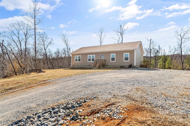 view of front of property featuring crawl space and gravel driveway