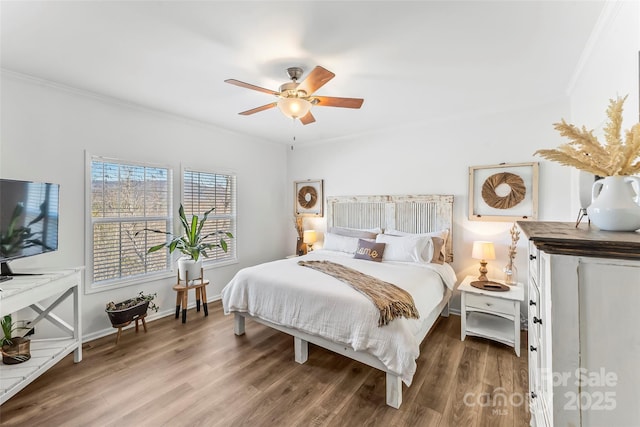 bedroom featuring a ceiling fan, baseboards, ornamental molding, and wood finished floors