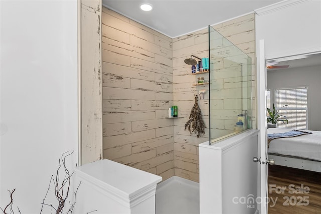 bathroom with a walk in shower, wooden walls, and ensuite bathroom