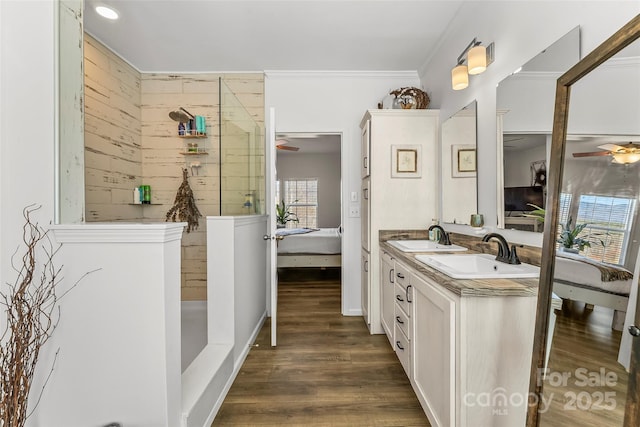 ensuite bathroom featuring wood finished floors, a sink, ensuite bath, and ceiling fan