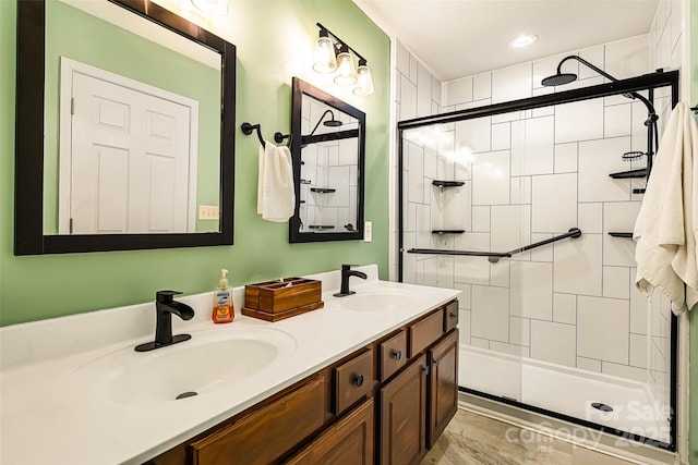 full bathroom featuring double vanity, a shower stall, and a sink