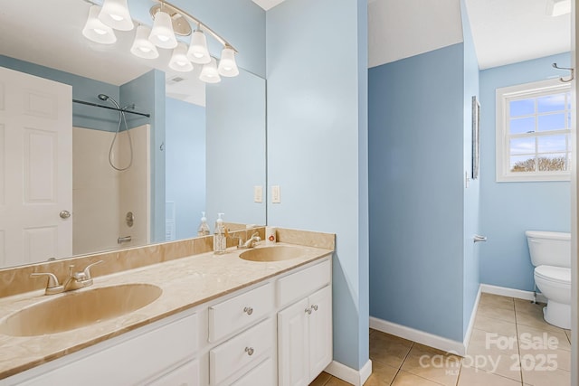 full bath with double vanity, a sink, toilet, and tile patterned floors