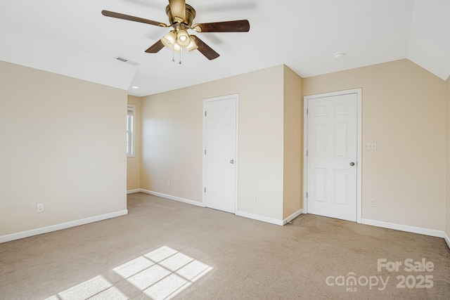 unfurnished bedroom with light carpet, baseboards, visible vents, ceiling fan, and vaulted ceiling