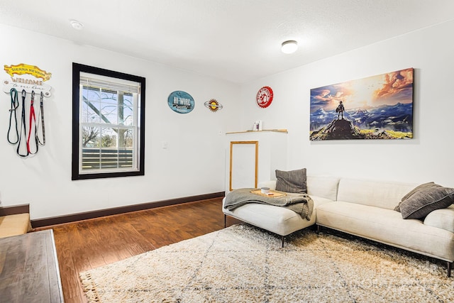 living room with baseboards and dark wood finished floors