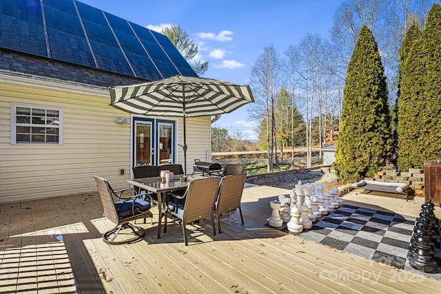 wooden deck featuring french doors and outdoor dining space