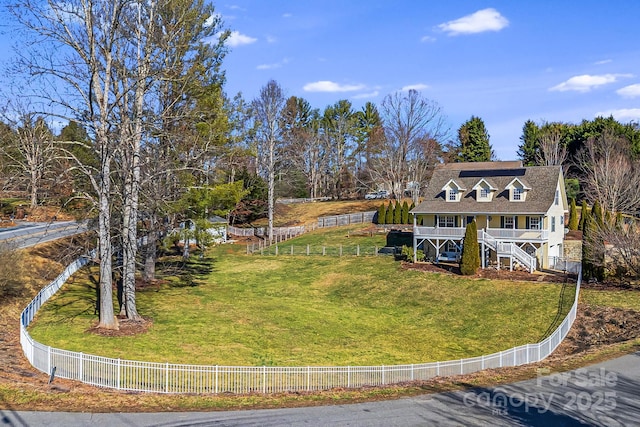 exterior space featuring a porch, fence private yard, stairway, and a front yard