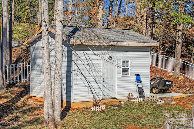 view of shed featuring fence