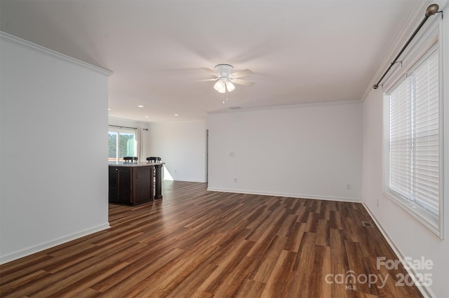 unfurnished living room featuring ceiling fan, visible vents, baseboards, and dark wood-type flooring