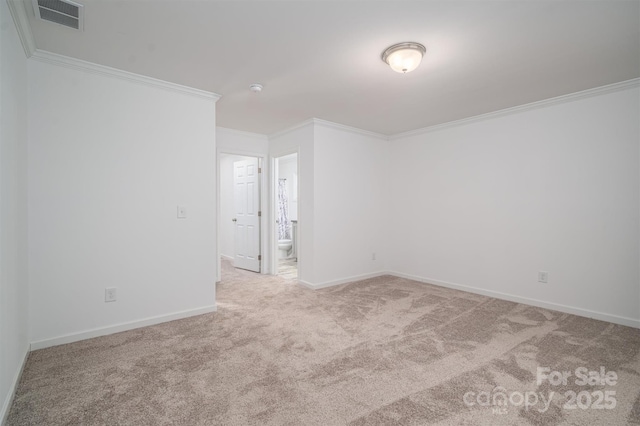 unfurnished room featuring ornamental molding, visible vents, light carpet, and baseboards