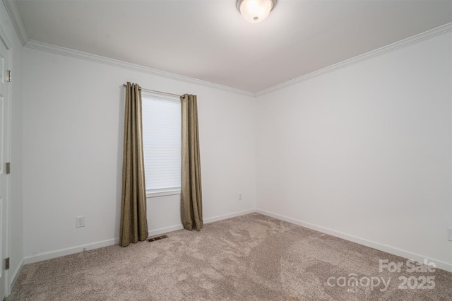 unfurnished room with light carpet, baseboards, visible vents, and ornamental molding