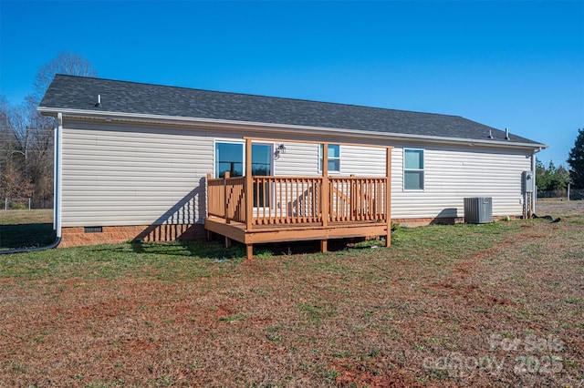 rear view of property with a shingled roof, a lawn, crawl space, a wooden deck, and central air condition unit