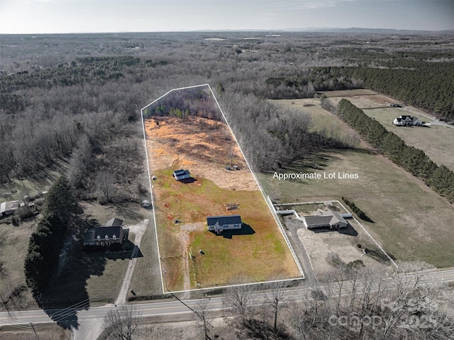 drone / aerial view featuring a wooded view