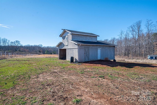 view of side of property with an outbuilding and a barn