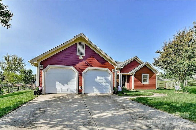 view of front of property with driveway, a front lawn, and fence