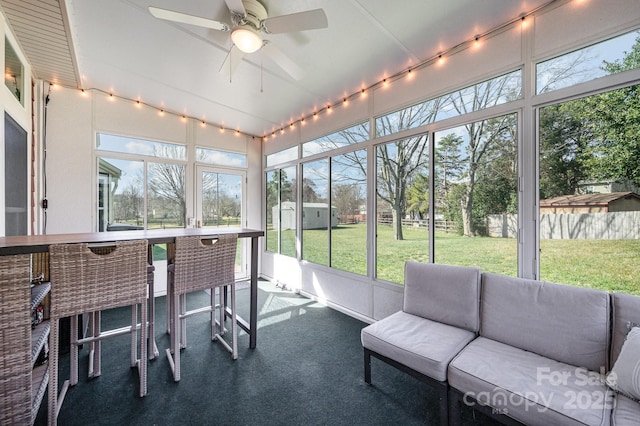 sunroom with ceiling fan and a healthy amount of sunlight