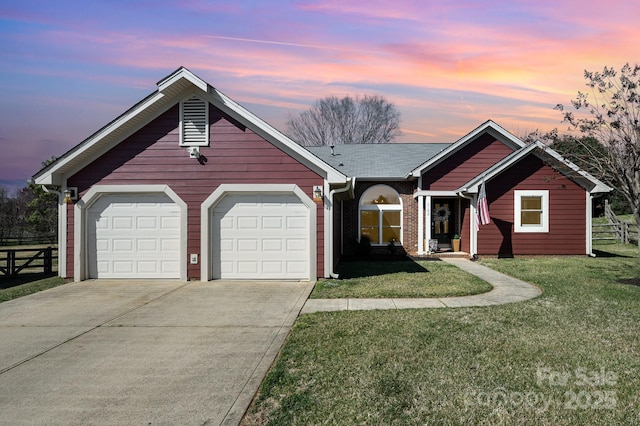 view of front of home with a garage, fence, concrete driveway, and a yard