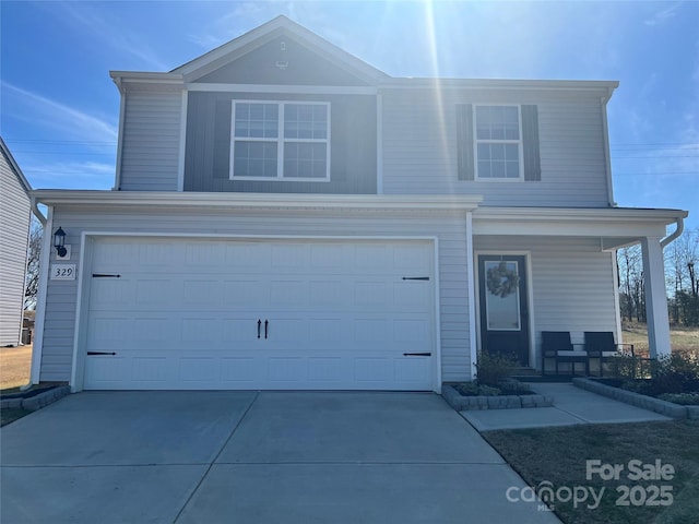 traditional home with driveway and an attached garage