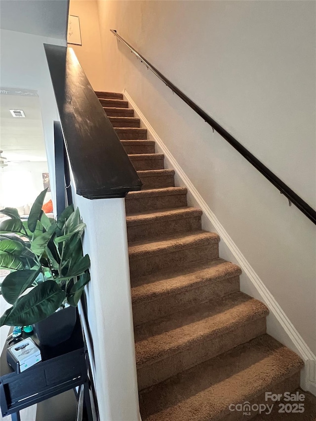 stairway featuring baseboards