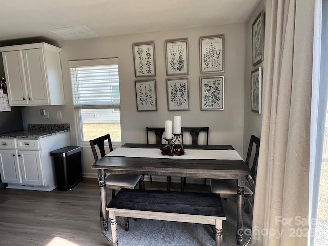 dining room with baseboards and wood finished floors