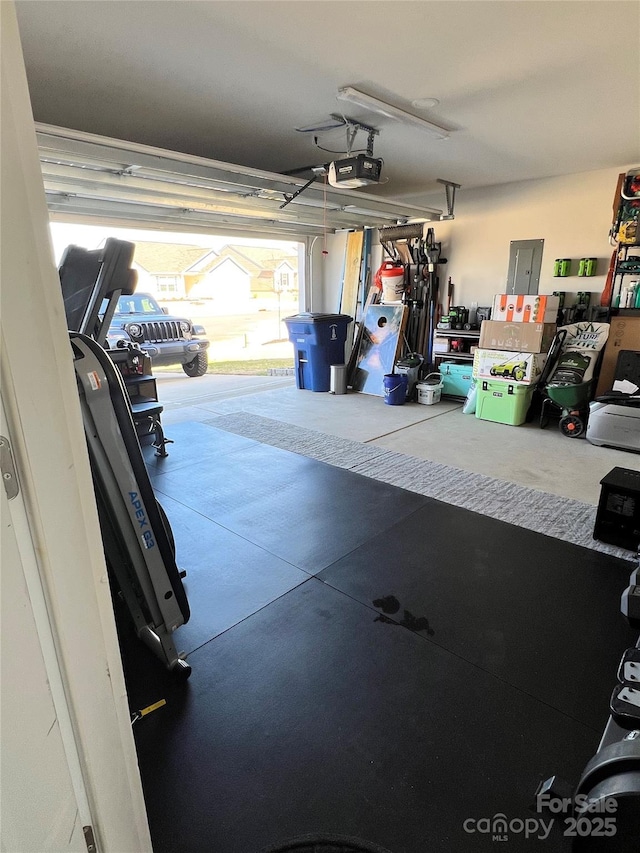 garage featuring electric panel and a garage door opener