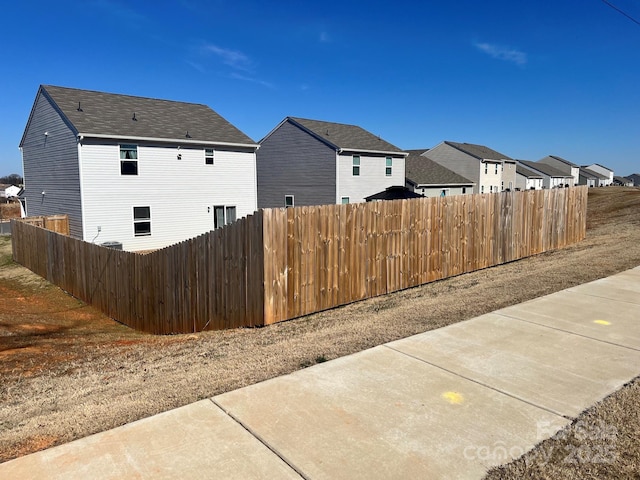 exterior space featuring a residential view, a patio area, and fence