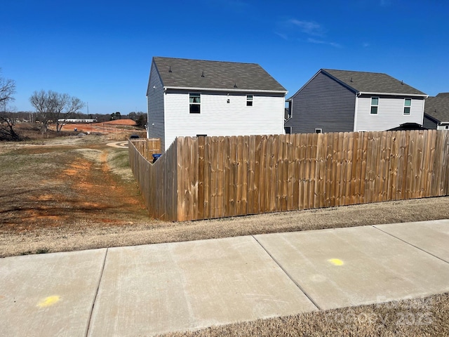 view of side of property featuring a patio and fence