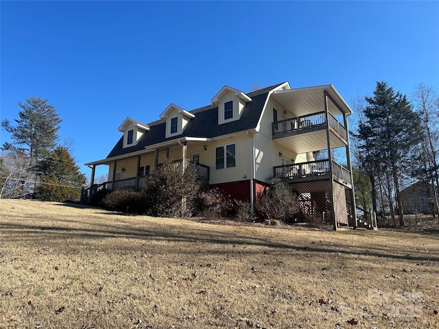 337 Knollwood Dr, Forest City, NC 28043 - view of front facade featuring a shingled roof, a front yard, and a balcony