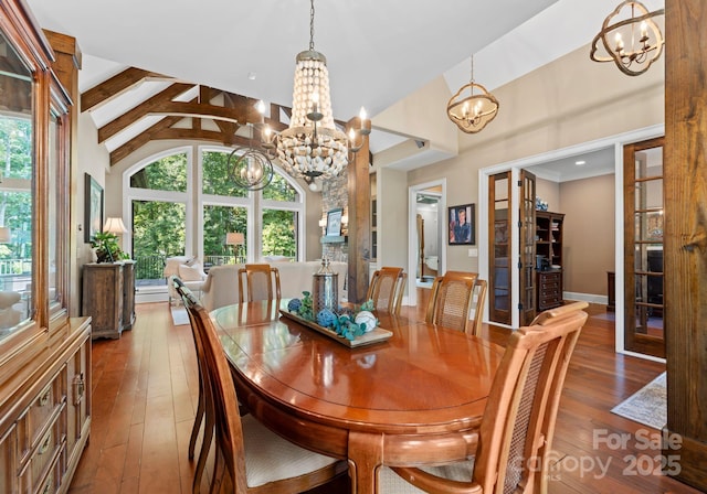 dining area with a healthy amount of sunlight, light wood-style flooring, and a notable chandelier