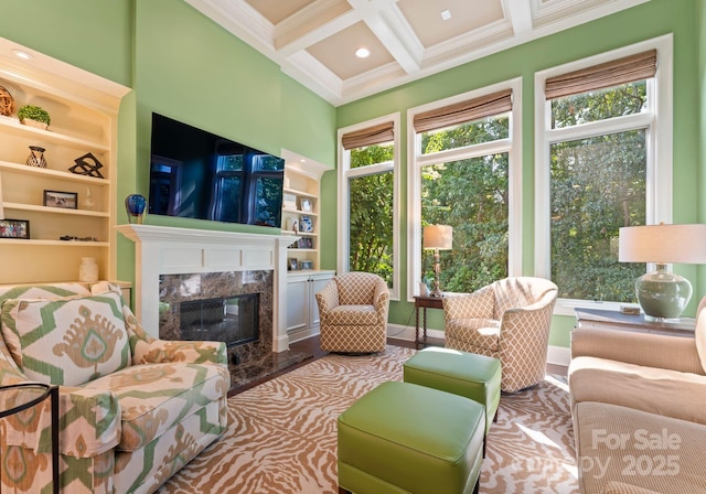 sunroom featuring a fireplace, coffered ceiling, and beam ceiling