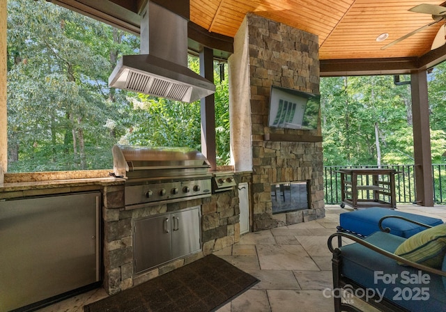 view of patio / terrace featuring a ceiling fan, grilling area, and an outdoor kitchen